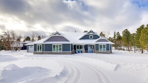 A large house with a snow-covered driveway and a garage. - Modern Lead Cabin w/ Hot Tub, 6 Mi to Skiing! (Lead)