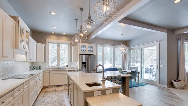 A spacious kitchen with a large island, white cabinetry, and pendant lighting. - Modern Lead Cabin w/ Hot Tub, 6 Mi to Skiing! (Lead)