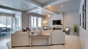 A modern living room with a sectional sofa, a coffee table, and a fireplace. - Modern Lead Cabin w/ Hot Tub, 6 Mi to Skiing! (Lead)