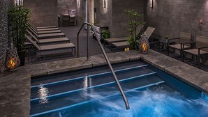 A pool area with a metal ladder, lounge chairs, and potted plants. - PEAK 8 SKI IN / SKI OUT 2BD/2BA at GRAND COLORADO. SLEEPS UP TO 8. (Breckenridge)