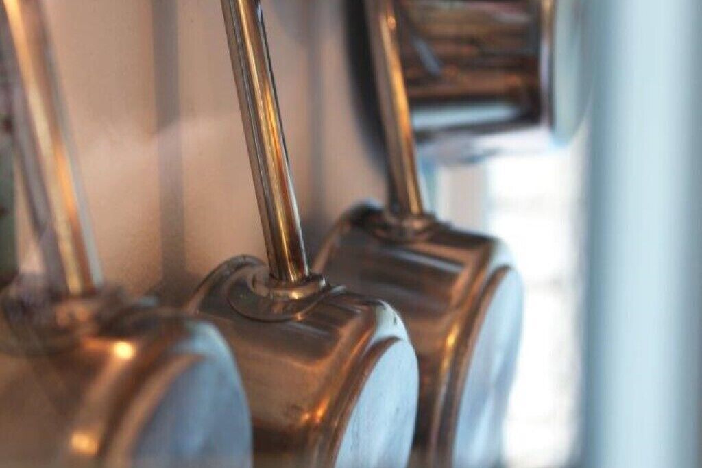 A close-up of metallic handles, likely part of a piece of furniture or equipment.