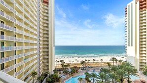 A high-rise hotel with a pool, beach view, and multiple balconies. - 9th-Floor Gulf Sunset Views | 2 King Beds | Shores of Panama 920 (Panama City Beach)