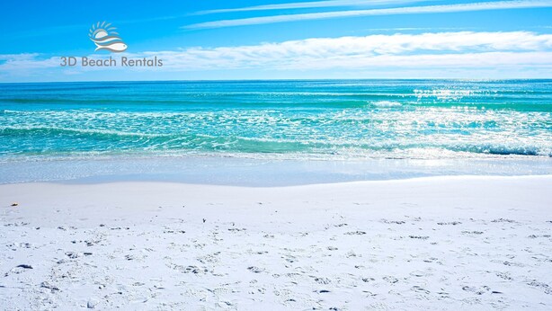 A beach with clear turquoise waters and a white sandy shore. - Ariel Dunes II 803 *Beach views* 3 pools* (miramar beach)
