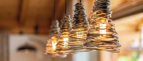 A room with a wooden ceiling and hanging spiral light fixtures.