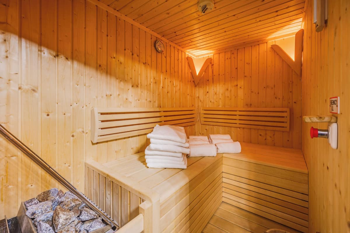 A wooden sauna with benches and towels.
