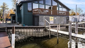 A modern building with a balcony, a dock, and a sign advertising a Lite beer brand. - Downtown apartment with water view and parking (Saugatuck)