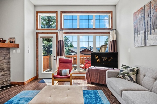 Living room on the main floor with a gas-lit fireplace and access to one of the two private balconies.