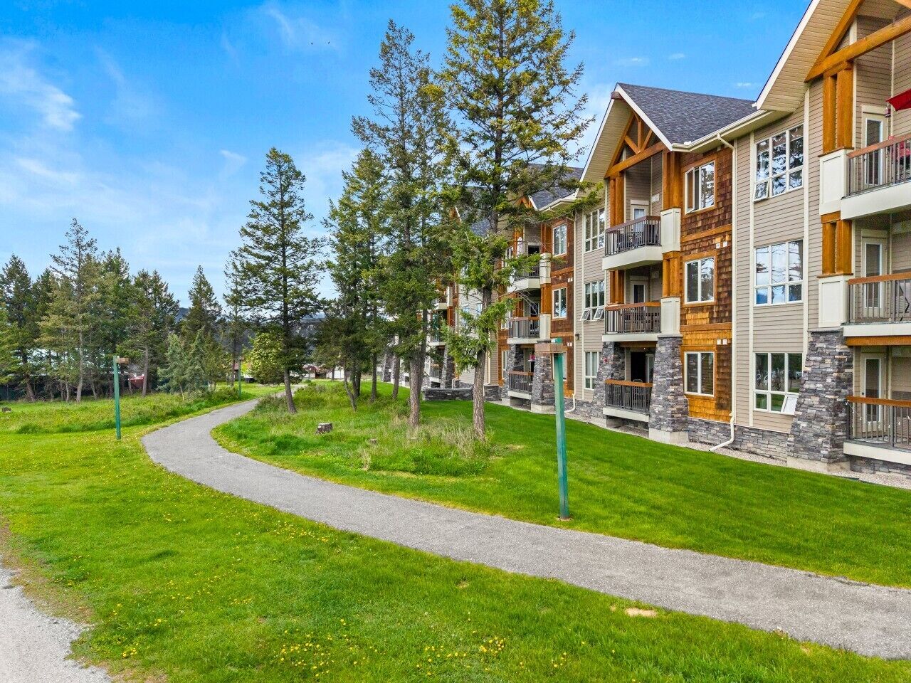 A multi-story building with a stone facade, wooden accents, and balconies.