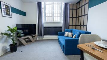 Premier Apartment, 1 Double Bed with Sofa bed, City View | Living area | 32-inch Smart TV with cable channels