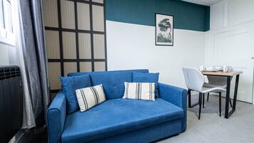 Premier Apartment, 1 Double Bed with Sofa bed, City View | Living area | 32-inch Smart TV with cable channels