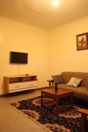 Deluxe House | Living area | 24-inch Smart TV with satellite channels