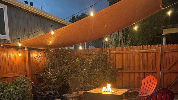 A patio with stone flooring, outdoor furniture, and a fire pit. - Historic, Unique, Walkable, Rail to Denver, Red Rocks (Arvada)