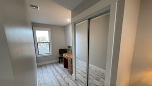 Une pièce dotée d’une grande porte coulissante, d’un bureau et d’une chaise.