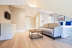 Deluxe Studio Apartment | Living area | Flat-screen TV, heated floors
