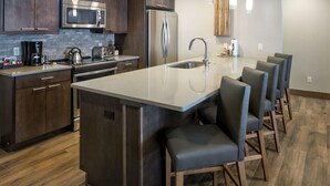 A modern kitchen with a central island, stainless steel appliances, and bar stools. - Ski In/Out! Easy Access-1 Bedroom Breckenridge Master-1.5 Baths-Sleeps 4 (Breckenridge)