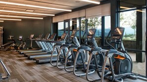 A gym with treadmills and elliptical machines, large windows, and a view of the outdoors. - Ski In/Out! Easy Access-1 Bedroom Breckenridge Master-1.5 Baths-Sleeps 4 (Breckenridge)