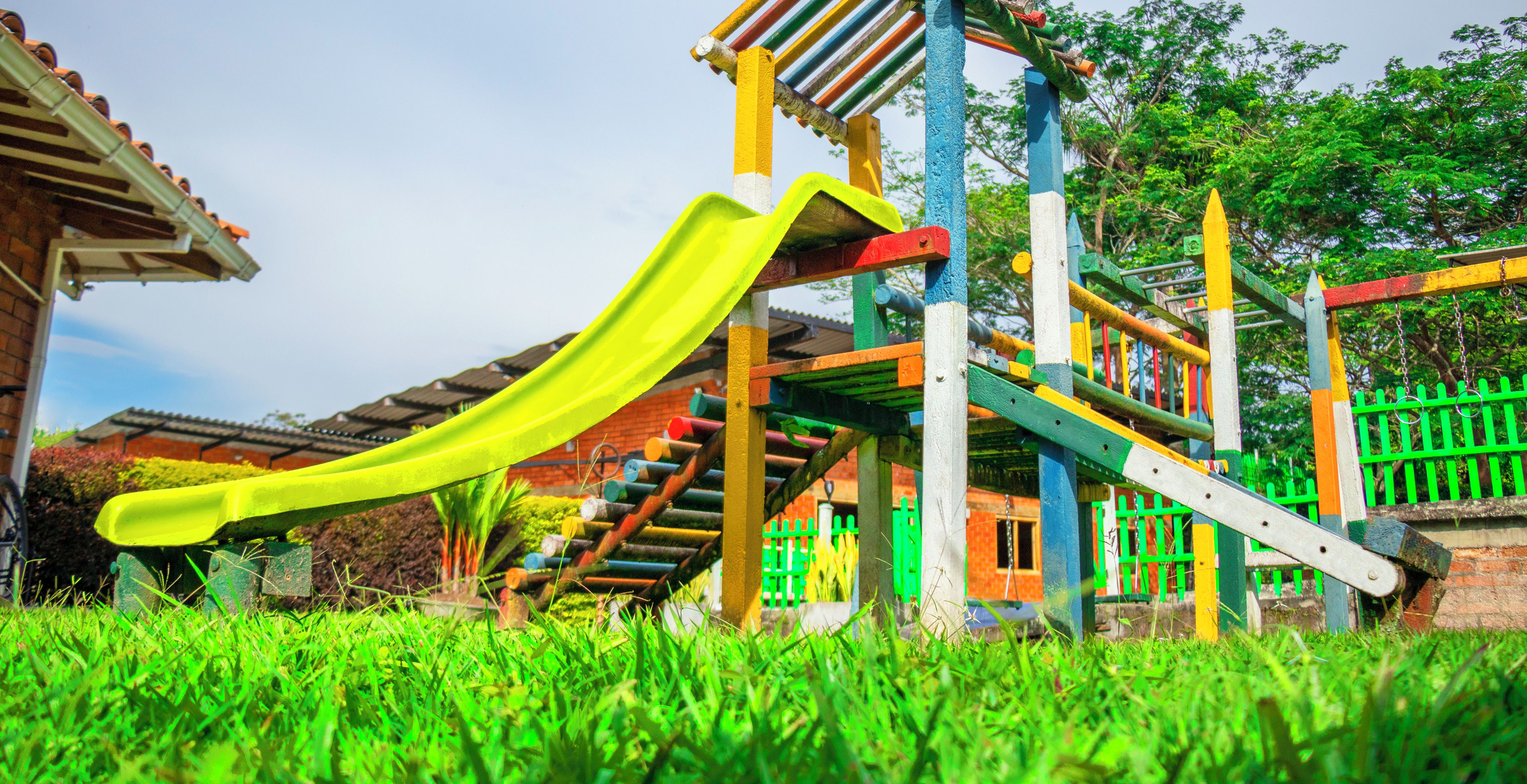 A playground with a slide and climbing structures.