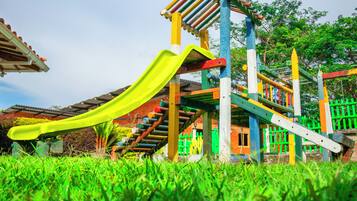 A playground with a slide and climbing structures.