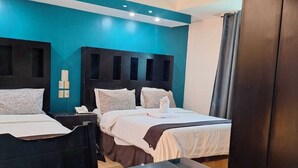 A modern hotel room with two beds, a ceiling fan, and a large mirror. - Hotel San Rafael Poza Rica (Poza Rica)
