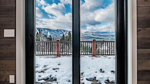 A double door with a view of a snowy landscape, mountains, and a wooden fence. - 3 Min to Slopes  | Stunning Mountain View (Newry)