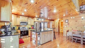 A spacious kitchen with wooden cabinets, stainless steel appliances, and a central island. - Waterfront Watauga Lake Home w/ Private Dock! (Butler)