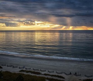 A beach with a calm sea and a cloudy sky. - HS-1025 Ocean View | Sleeps 6 | Pools, Lazy River+ (Myrtle Beach)