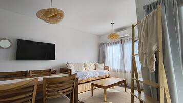 Comfort Studio | Living area | Flat-screen TV