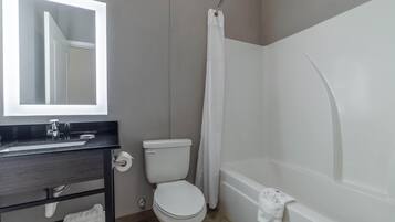 A bathroom with a toilet, sink, and bathtub.