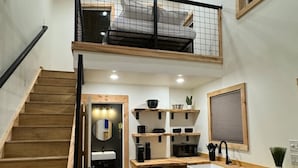 A modern kitchen with wooden cabinets, a built-in dishwasher, and a small island with a sink.