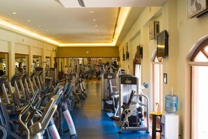 A gym with treadmills, weight machines, and a water dispenser.