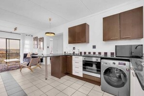 Enjoy meals in the kitchen with an oven and washing machine, and take in the view from the large window.