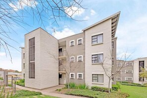 Residents enjoy a tranquil atmosphere surrounded by lush greenery and expansive views from balconies.