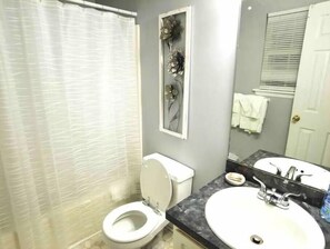 Combined shower/bathtub, towels, toilet paper