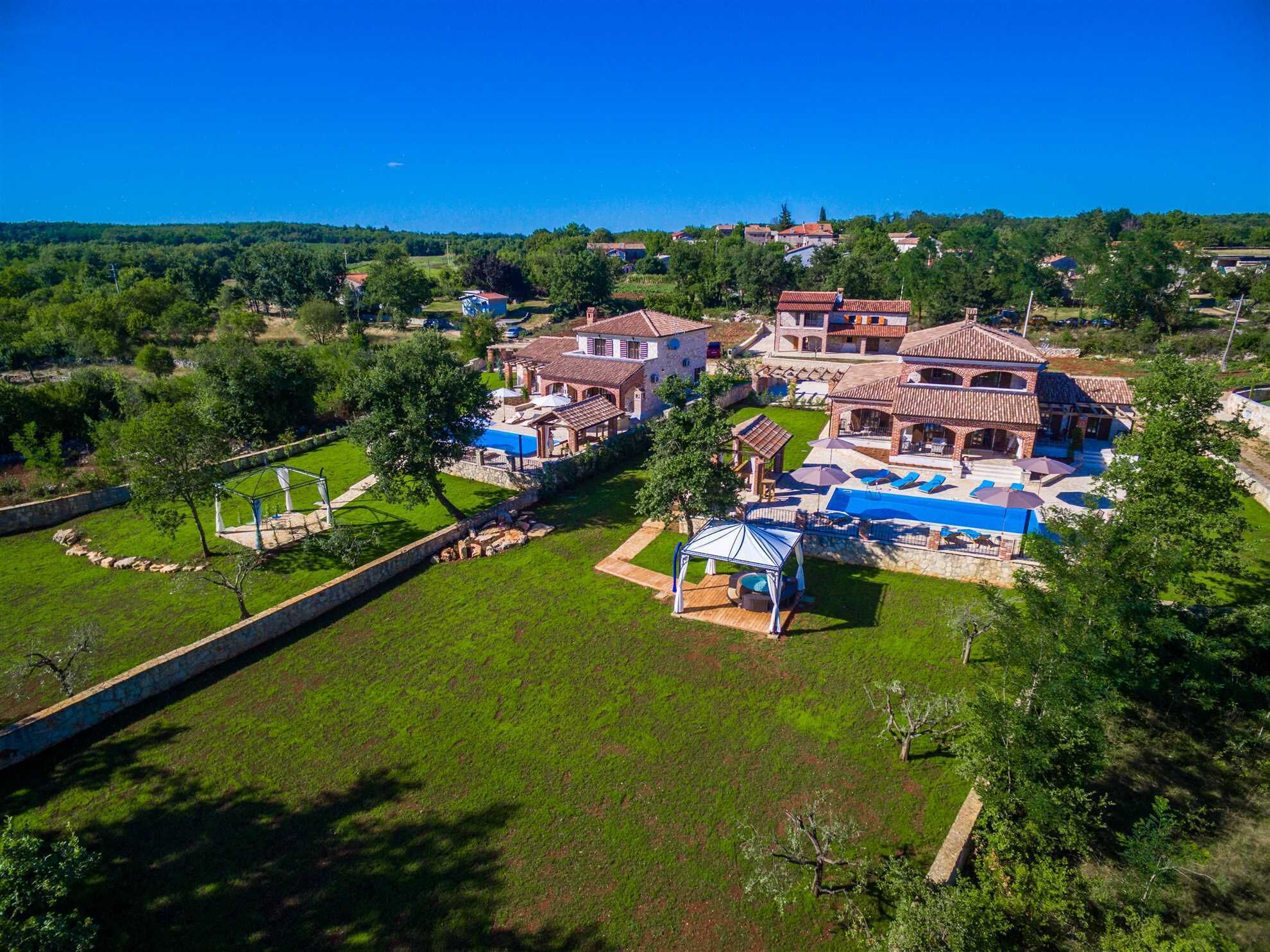 A large property with multiple buildings, a swimming pool, and a well-maintained lawn.