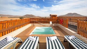 A pool area with lounge chairs and a view of mountains. - Vacation Home 'Casa Glory' with Mountain View, Wi-Fi and Air Conditioning (Antigua)