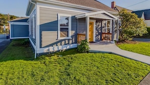 A single-story house with a front porch, a garage, and a well-maintained lawn. - Located in Northtown Arcata, The Yellow Doors `A` (Arcata)