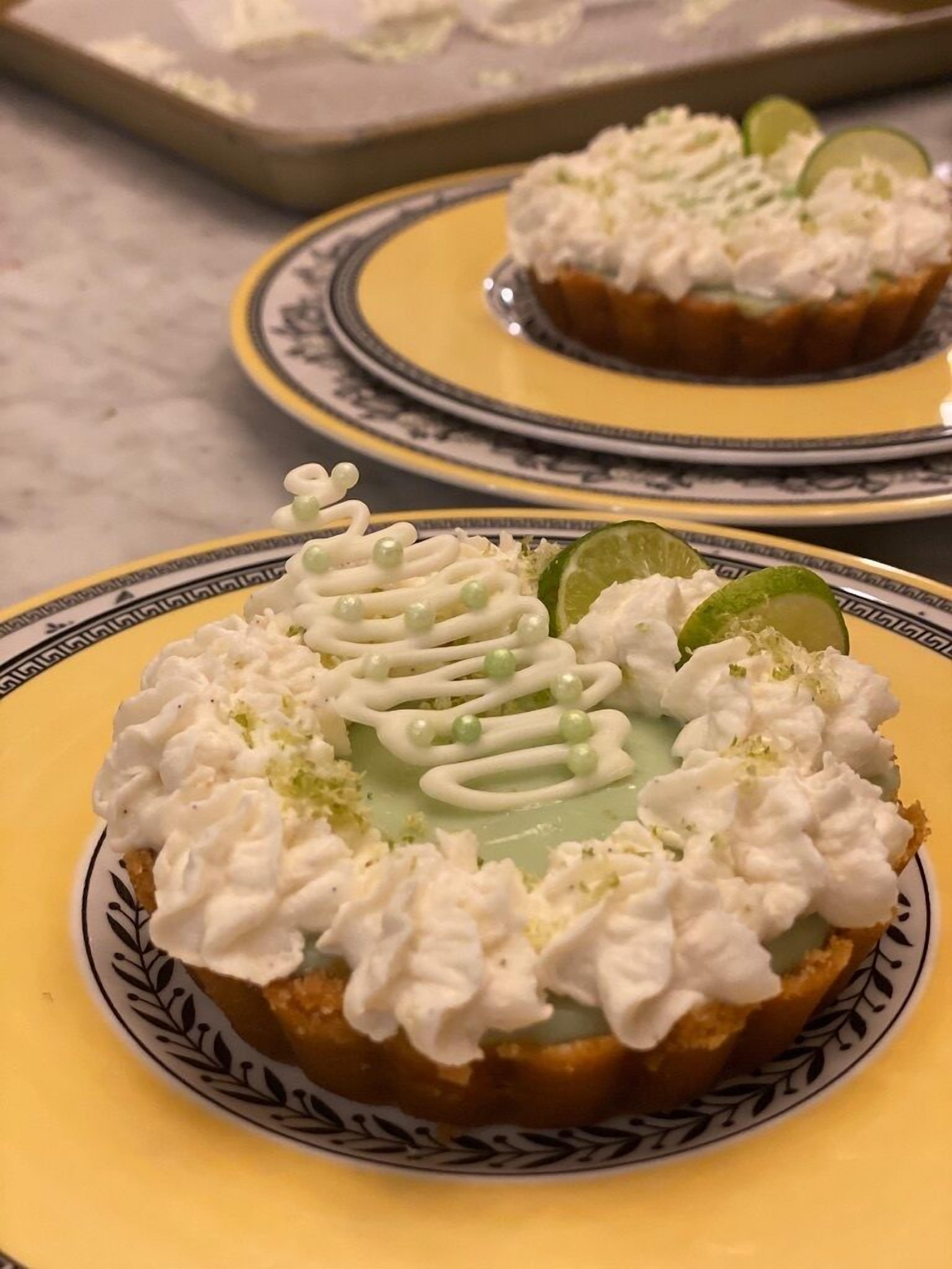 A dessert on a plate with whipped cream and lime slices.