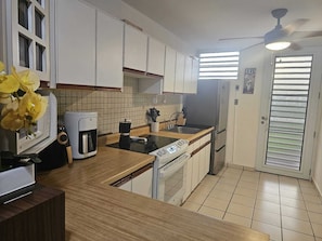 Enjoy cooking in this well-equipped kitchen with an oven, dishwasher, and coffee maker.