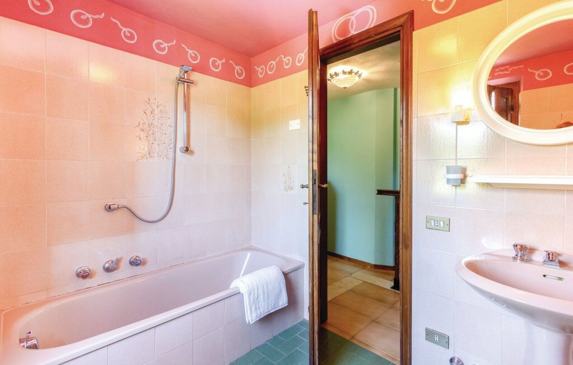 A bathroom with a bathtub, a shower, and a sink.