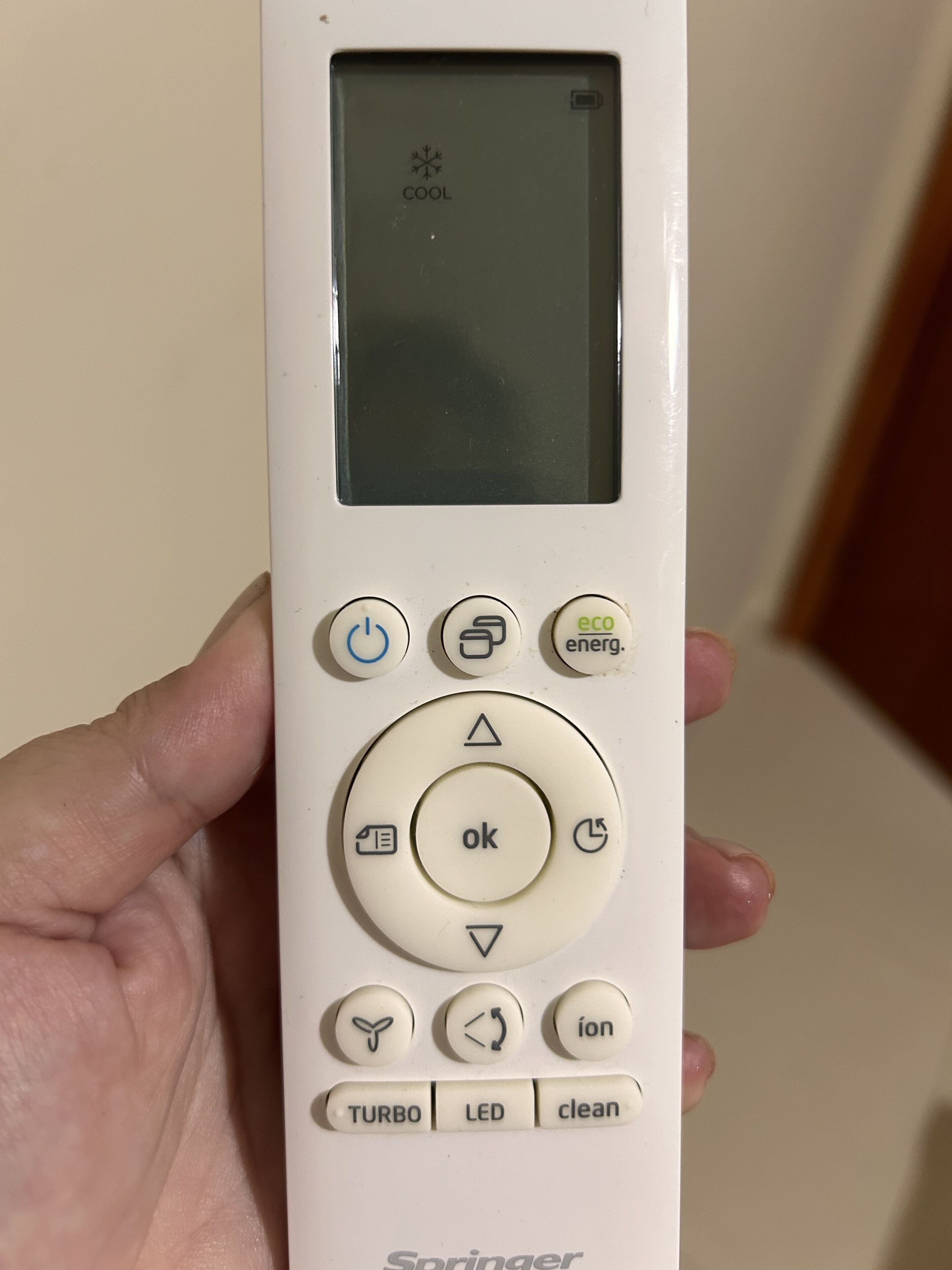 A white remote control with a screen, buttons labeled "eco," "ok," "TURBO," "LED," and "clean."