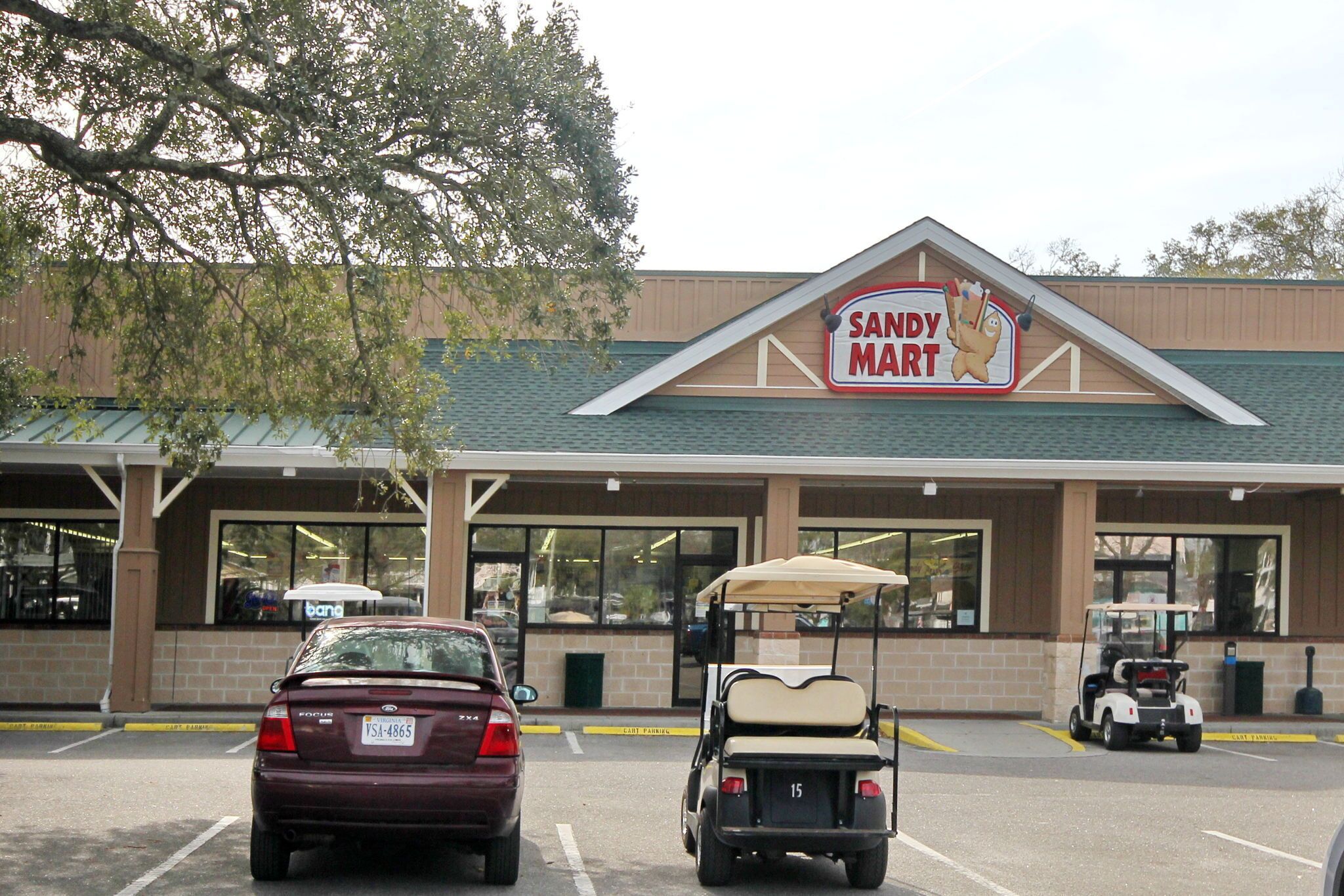 A Sandy Mart store with a parking lot, a golf cart, and a Focus car.