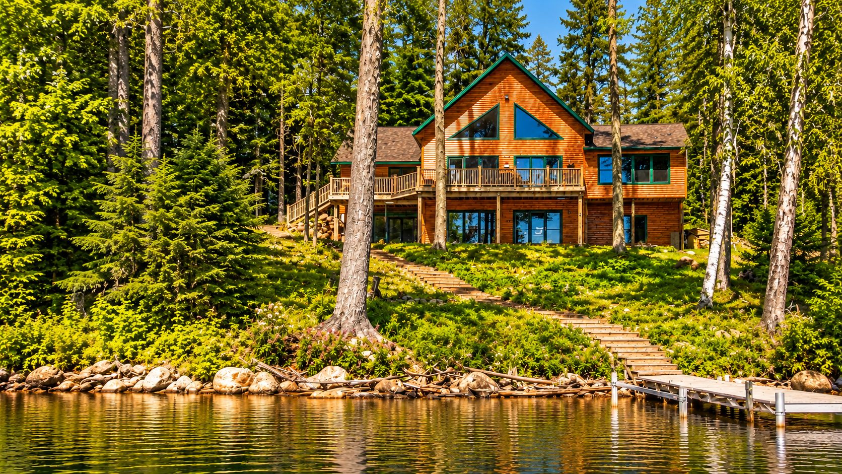 Private lakefront cabin with forest views, large deck, and dock access