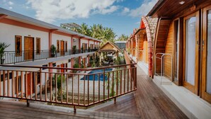 A resort with multiple wooden buildings, a pool, and a covered outdoor area. - The Garuda Hostel & Accomodation (Penida Island)