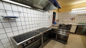 A kitchen with a stove, oven, and a microwave.