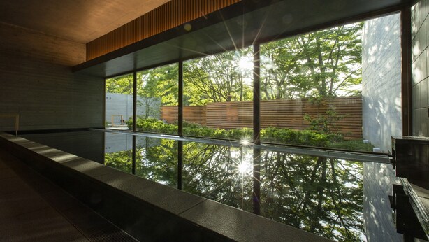 A modern interior with large windows, a concrete ceiling, and a wooden slat design. - Sport & Do Resort  RESOL NO MORI (Nagara)