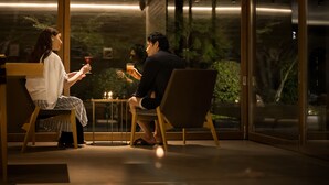 A couple seated at a table in a dimly lit room with large windows overlooking a garden. - Sport & Do Resort  RESOL NO MORI (Nagara)