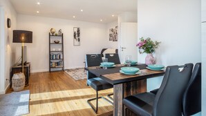 A dining area with a wooden table, black chairs, and teal dinnerware.