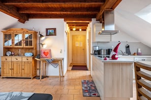 A cozy kitchen with wooden cabinets, a dining table, and a kitchen island.