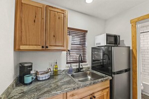 Fridge, microwave, coffee/tea maker, cookware/dishes/utensils