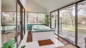 A modern bathroom with a glass-enclosed hot tub, large windows, and a skylight. - Hot Tub, Deck & Grill: Brookshire Gem Near Venues (Brookshire)